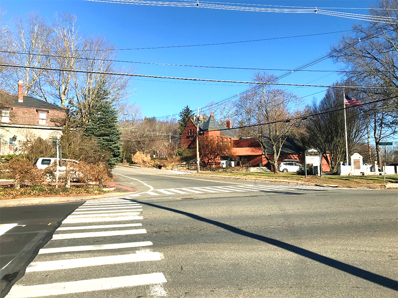 Figure 8 - View across Great Road (Route 117) of Northwest Intersection Corner. Image shows two crosswalks meeting on the street corner where there are two pedestrian detectable warning strips and the sidewalk is made of pavement. Figure 8 - View across Great Road (Route 117) of Northwest Intersection Corner. Image shows two crosswalks meeting on the street corner where there are two pedestrian detectable warning strips and the sidewalk is made of pavement.